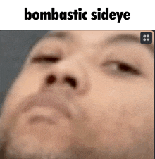 a blurred image of a man 's face with the words bombastic sideeye above it