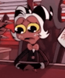 a cartoon character is sitting at a table with a bow tie and big eyes .