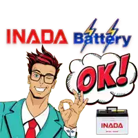 a man in a suit and tie giving an ok sign next to an inada battery