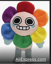 a stuffed rainbow flower with a crying face is on a website called aliexpress.com