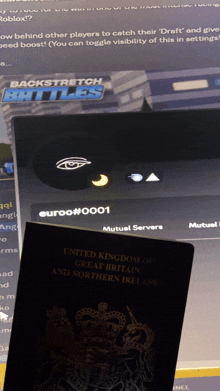 a passport from the united kingdom of great britain and northern ireland sits on top of a computer screen