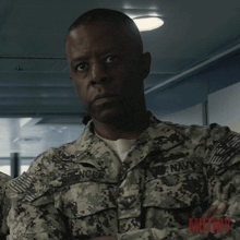 a man in a military uniform has the name spencer on his uniform