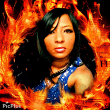 a picture of a woman in a blue dress is surrounded by flames and has picplus written on the bottom