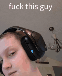 a person wearing headphones with the words " fuck this guy " written above them