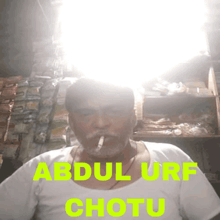 a man smoking a cigarette with the name abdul urf chotu written on the bottom