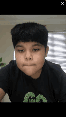 a boy wearing a black shirt with the letter a on it