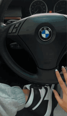 the bmw logo is on the steering wheel of a black car