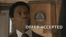 a man in a suit and tie is smiling and says offer accepted my man