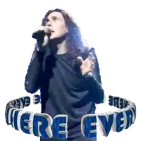 a man singing into a microphone with the words here ever behind him