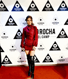 a woman stands in front of a coco rocha wall