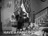 a black and white photo of a man in a living room with the words `` have a fabulous time '' written on it .