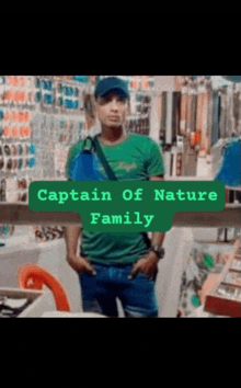 a man in a green shirt is standing in front of a store with the words captain of nature family above him