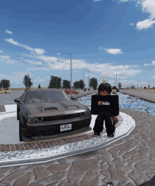 a person wearing a youtube shirt stands in front of a car