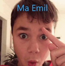 a close up of a child 's face with the name ma emil written above it