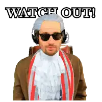 a man wearing a wig and sunglasses is sitting in a chair with the words watch out behind him