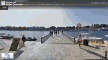 a screenshot of a video converter shows people walking on a bridge over a body of water