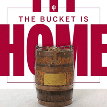 a poster that says the bucket is home with a wooden barrel in front of it