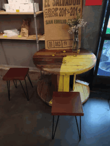 a wooden table in front of a cardboard box that says el salvador crop 2013-2014