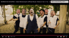 a group of men are laughing in a video titled mordechai shapiro hakol mishamayim