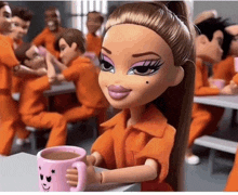 a bratz doll is sitting at a table holding a pink cup of coffee .