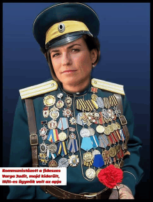 a woman in a military uniform is holding a red carnation