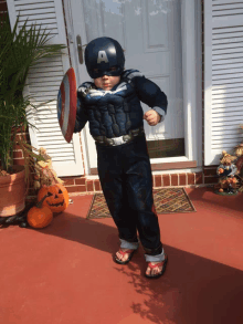 a young boy dressed in a captain america costume