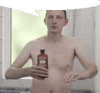 a shirtless man holding a bottle of herbal essences