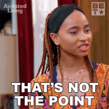 a woman with braids is making a funny face and saying that 's not the point