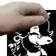 a close up of a person 's hand holding a cartoon character .
