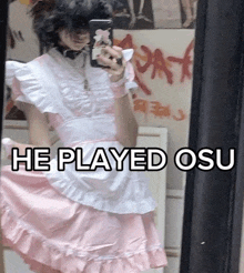 a person taking a selfie in front of a mirror with the words he played osu