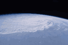 a view of the earth from space shows a hurricane on the horizon