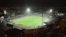 an aerial view of a soccer field at night with a sign that says ' coca cola ' on it