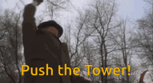 a man with his fist in the air with the words push the tower below him