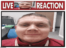 a man is smiling in front of a sign that says live reaction .