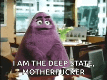 a purple puppet is sitting at a desk and says i am the deep state motherfucker