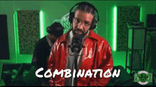 a man wearing headphones and a red jacket is sitting in front of a microphone with the word combination written on it .