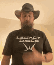 a man with a beard is wearing a legacy discs t-shirt