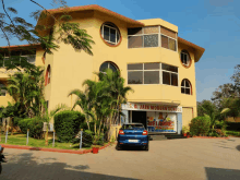 a blue car is parked in front of a building that says ' s.d. jain modern school '