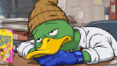 a cartoon of a duck laying down next to a box of ever colored