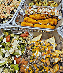 a variety of food in aluminum foil trays