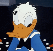 donald duck is wearing a blue shirt and a bow tie