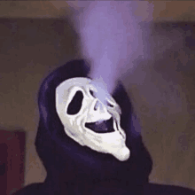 a person wearing a scream mask with purple smoke coming out of their mouth .