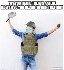 a man wearing a helmet and a mask is holding a sieve and grenade