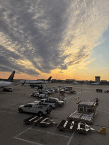 a united airlines plane sits on the tarmac at sunset