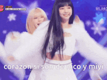 a woman in a white dress is dancing with the words corazon si son de nico y miyi