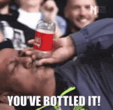 a man drinking from a coca cola bottle with the words you 've bottled it below him