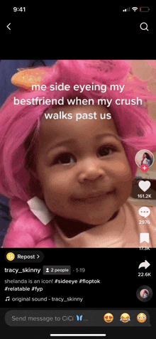 a baby is wearing a pink wig and smiling in a tiktok video