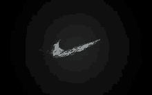 a white nike logo on a black background with water splashing out of it .