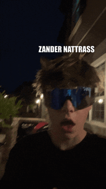 a man wearing sunglasses with the words zander nattrass on the top