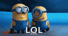 two minions wearing goggles and overalls are standing next to each other and talking .